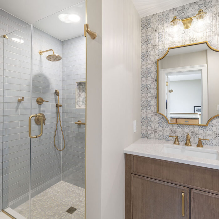 Modern bathroom with glass shower and brass fixtures