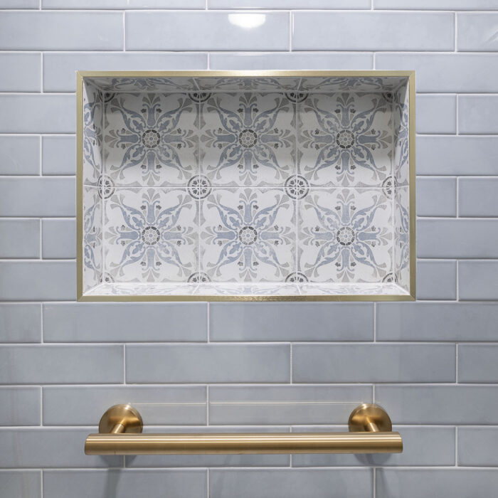 Tiled shower niche with brass towel bar