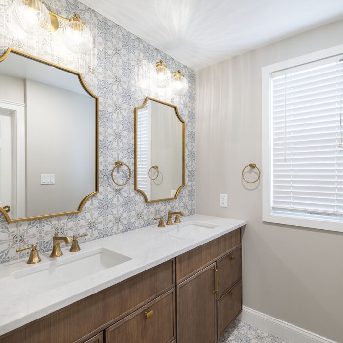 Modern double vanity with gold-framed mirrors