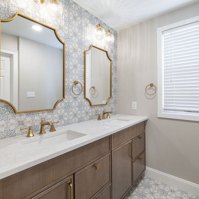 Double-sink bathroom vanity with gold mirrors