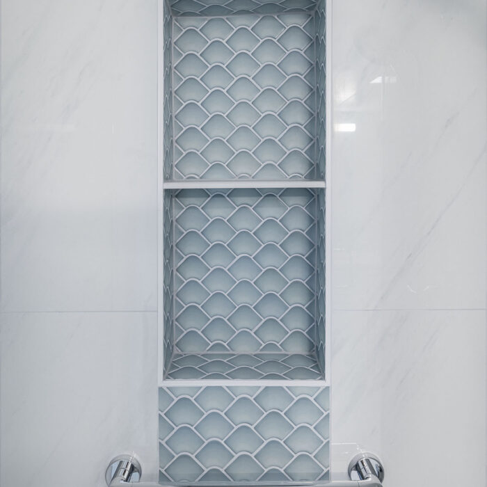 Shower niche with scallop tiles and grab bar