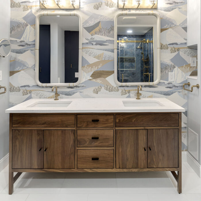 Double sink wooden vanity with patterned wallpaper