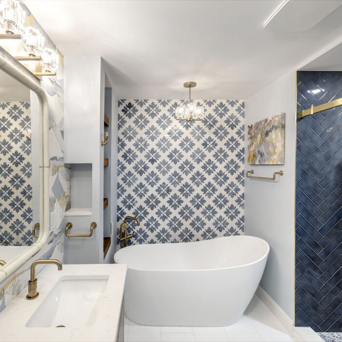 Freestanding tub with patterned tile wall, navy shower