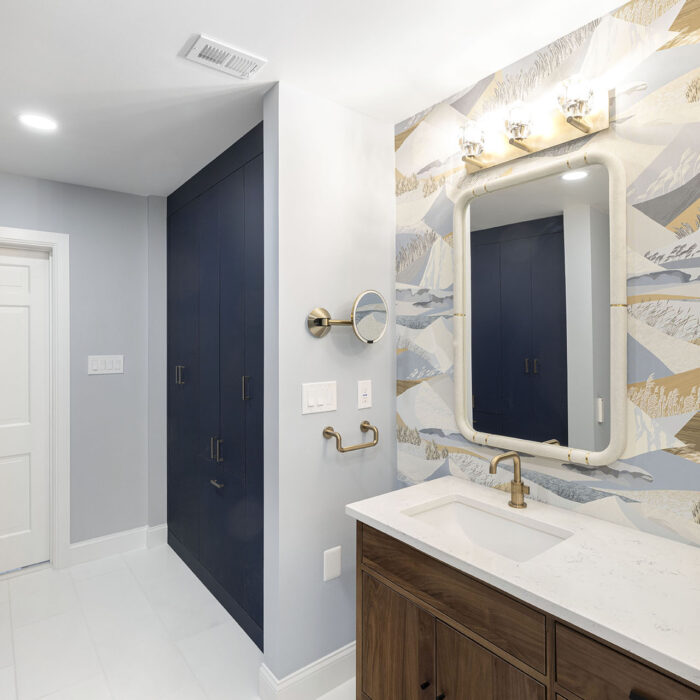 Modern bathroom vanity, navy cabinets, patterned wallpaper