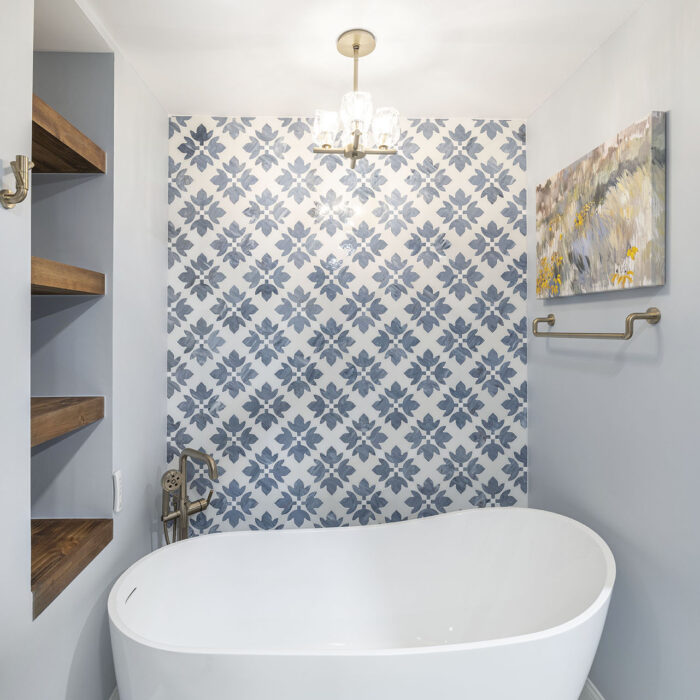Modern freestanding tub with blue tile wall