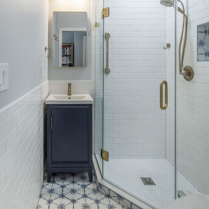 Small bathroom with glass shower and patterned floor