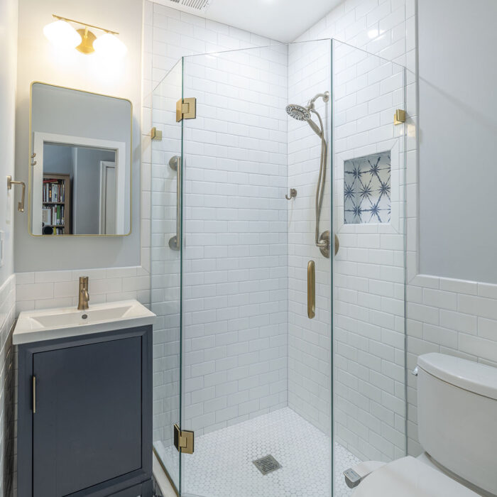 Modern bathroom with glass shower and patterned tile