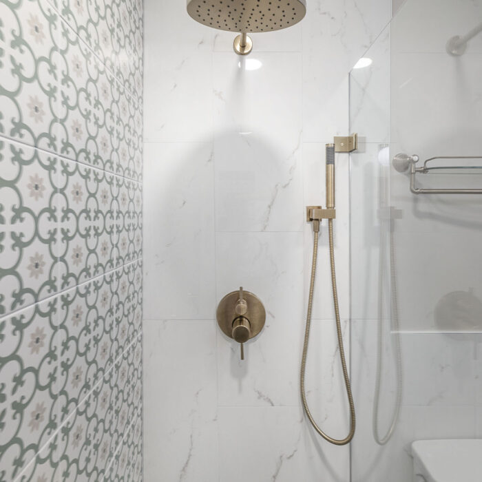 Modern bathroom shower with brass fixtures