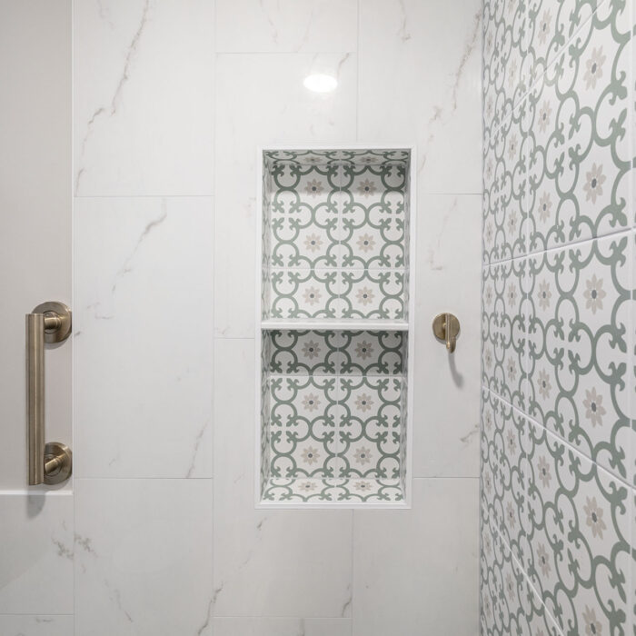 Patterned tile shower niche with brass grab bars