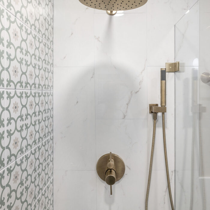 Brass rainfall shower with patterned tile wall