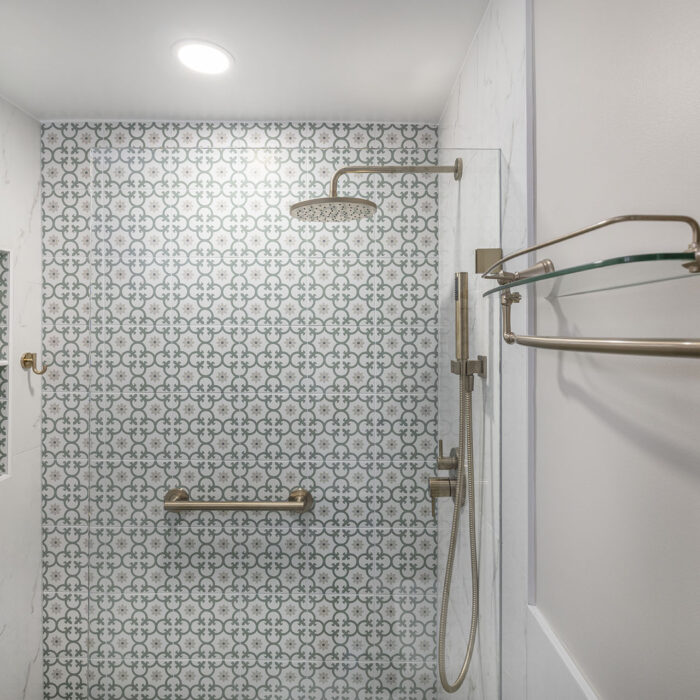 Patterned tile shower with brass fixtures
