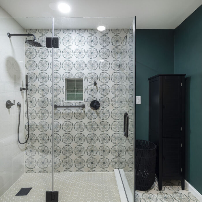 Modern glass shower with patterned tile wall