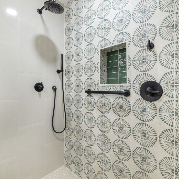Patterned tile walk-in shower with black fixtures