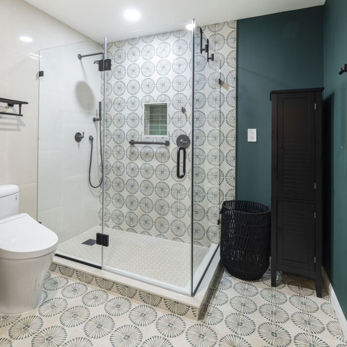 Modern bathroom with glass shower and patterned tiles