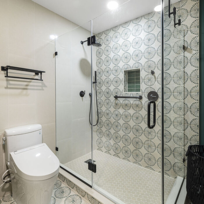 Modern bathroom with glass shower and patterned tiles