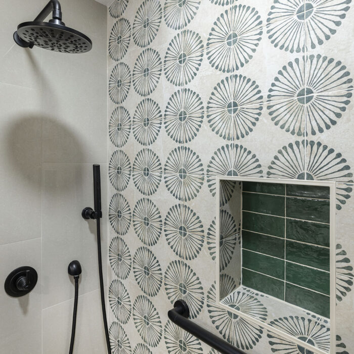 Modern shower with patterned tile and grab bar