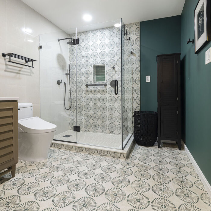 Modern bathroom with glass shower and patterned tiles
