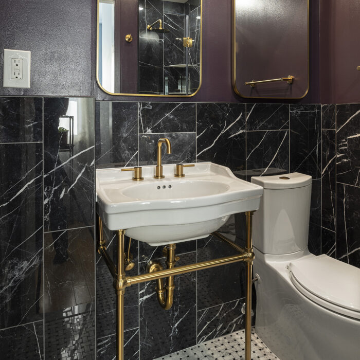 Modern bathroom with black marble and gold fixtures