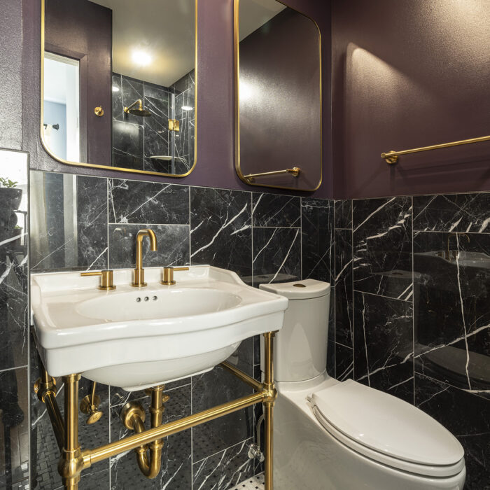 Modern bathroom with black marble and gold fixtures