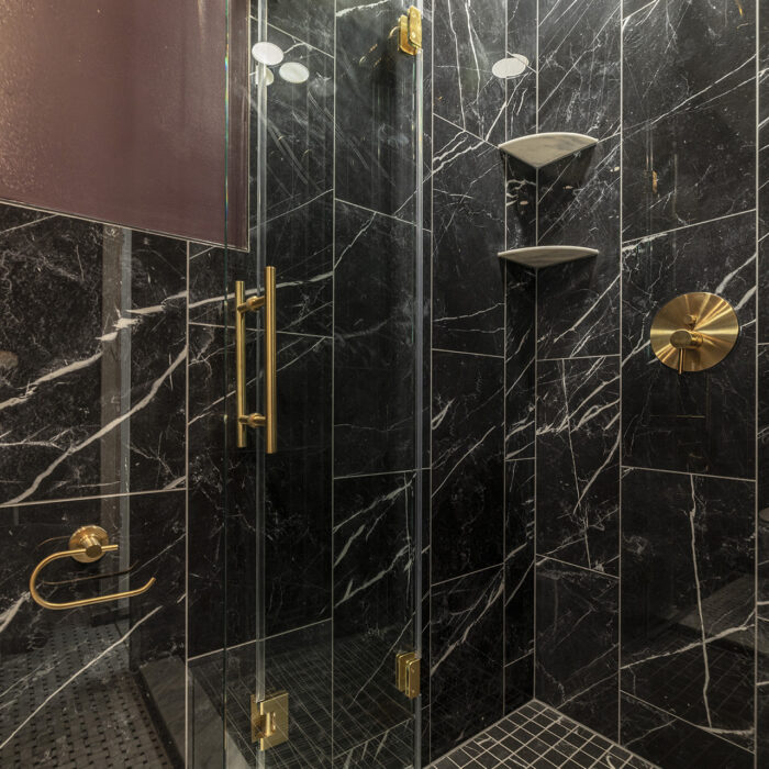 Black marble shower with brass fixtures