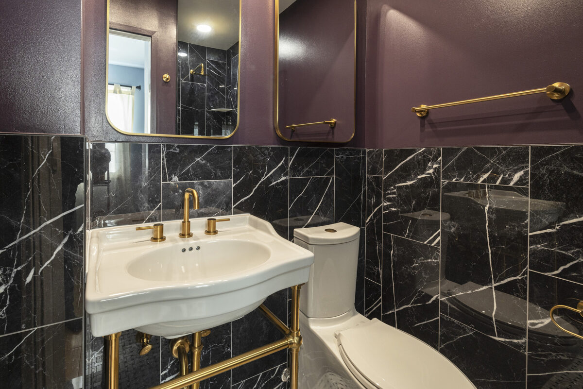 Elegant bathroom with marble tiles and gold fixtures