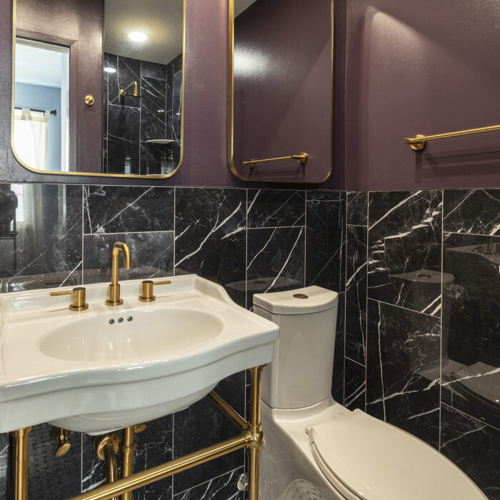 Elegant bathroom with marble tiles and gold fixtures